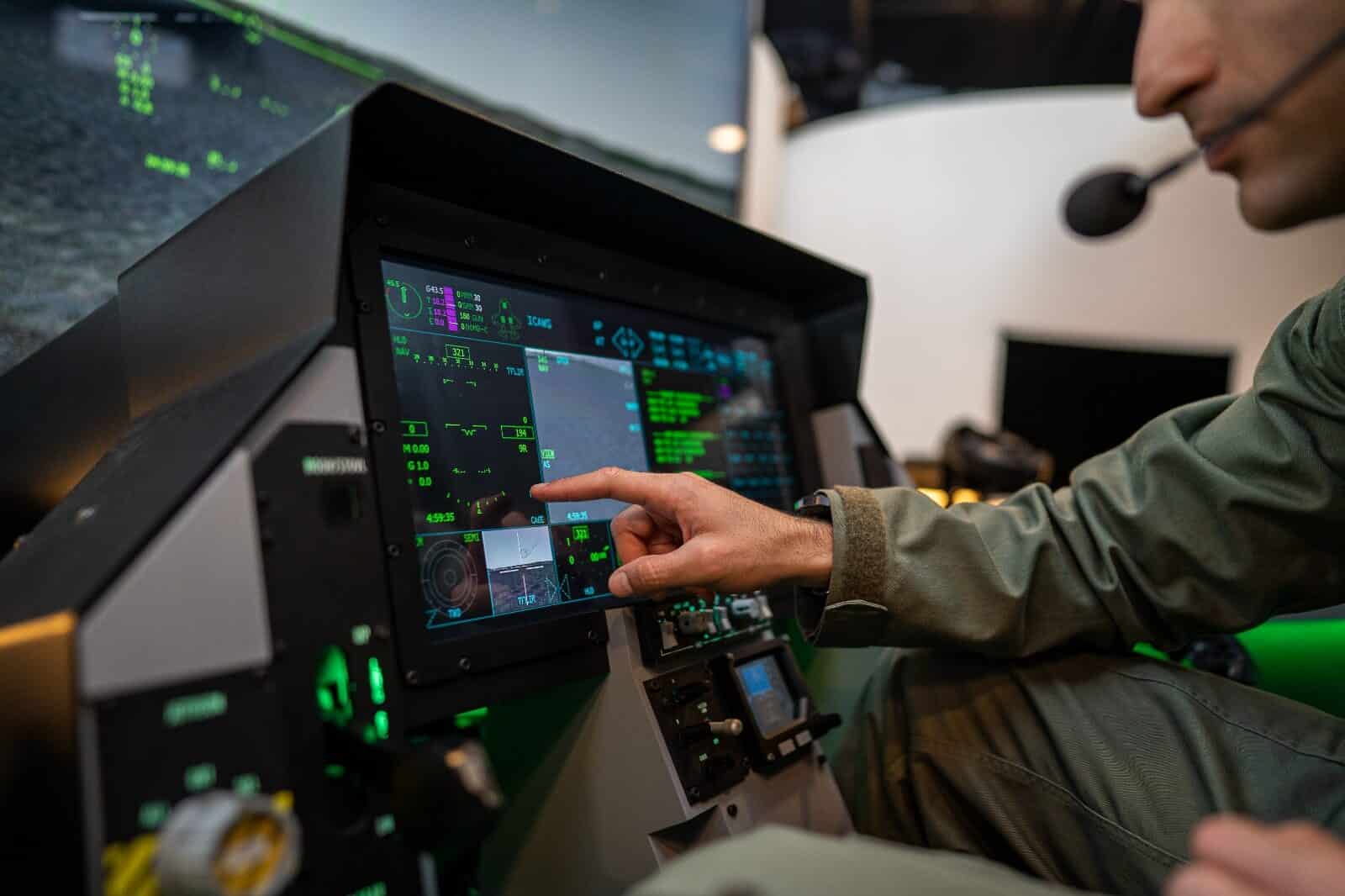 man pointing at the simulator screen